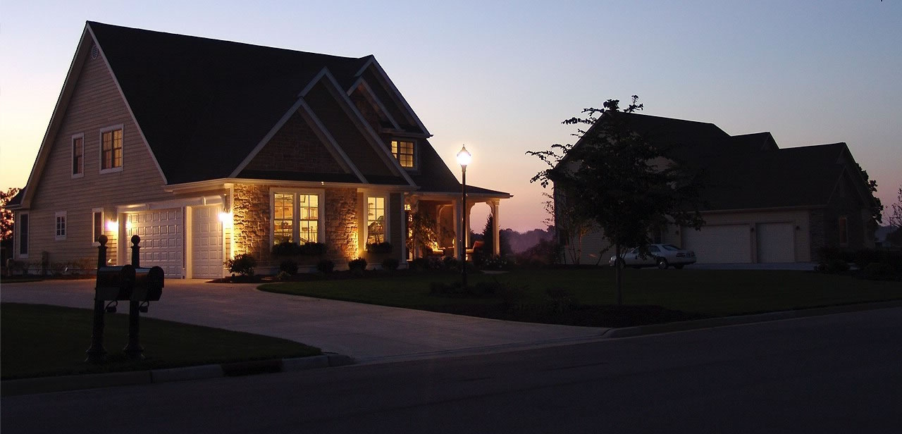 Image of a house at night, in a lightning storm, with its power still on